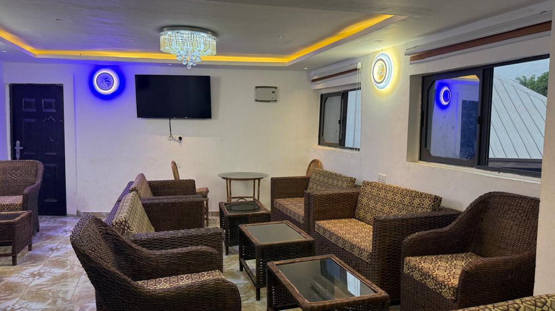 Woven armchairs and tables in the window-lit conference space.
